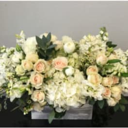 Low white and blush rose and hydrangea arrangement in a rectangular wooden box