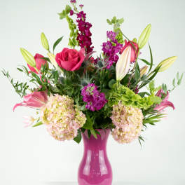 Pink and purple mixed bouquet in a magenta vase
