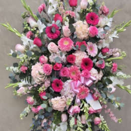 Large pink and white floral standing spray on an easel