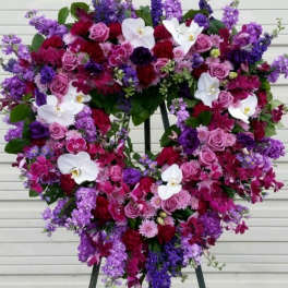 Heart-shaped floral wreath with pink, purple, and white flowers