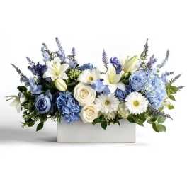 Blue and white floral arrangement in a white rectangular box