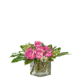 Pink roses arranged in a clear glass vase