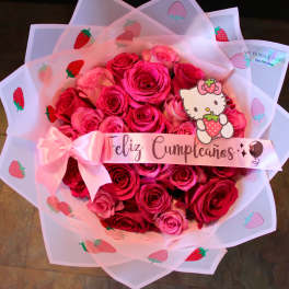 Pink rose bouquet wrapped in strawberry-printed paper with a birthday ribbon