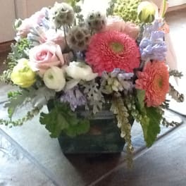 Mixed bouquet with pink roses, gerbera daisies, and calla lilies in a vase