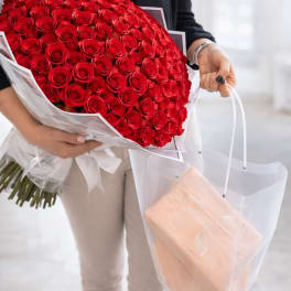Large bouquet of red roses wrapped in white paper