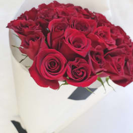 Bouquet of red roses wrapped in white paper