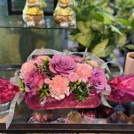 Pink and purple roses with carnations in a candy-shaped gift box