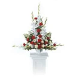 Red and white floral arrangement on a white pedestal