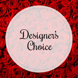 Red roses with a circular label reading "Designer’s Choice"