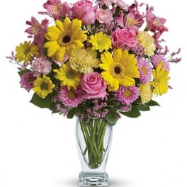 Pink and yellow mixed bouquet in a clear glass vase