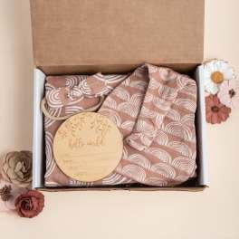 Baby gift box with patterned outfit and wooden milestone disc
