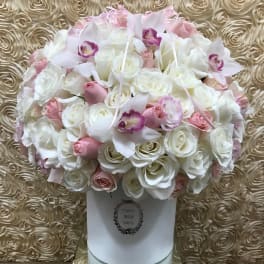 Pink and white rose bouquet with orchids in a white box