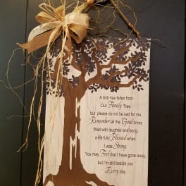 Wooden sympathy sign with a tree graphic and burlap bow