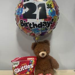 Birthday balloon with a teddy bear and a bag of Skittles candy