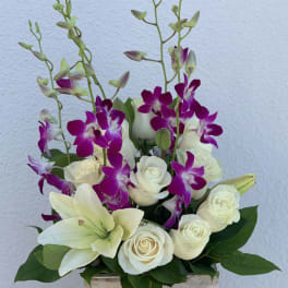 White roses and lilies with purple orchids in a wooden box