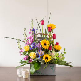 Mixed bouquet with sunflowers, roses, and irises in a decorative box