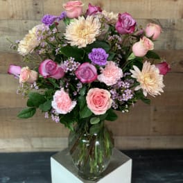 Pink and cream mixed bouquet in a clear glass vase