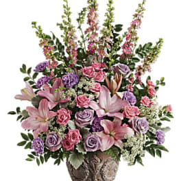 Pink and lavender floral arrangement in a decorative vase