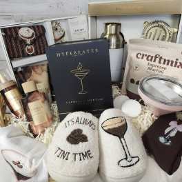 Gift basket with cocktail mix, tumblers, socks, and accessories