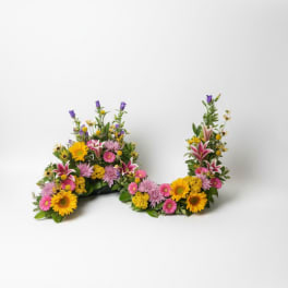 Two colorful floral arrangements shaped like the letter U on a white background