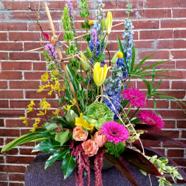 Tall mixed flower arrangement with pink gerberas, roses, and yellow lilies