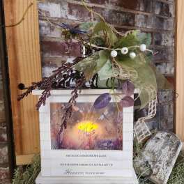 Decorative memorial lantern with faux greenery and berries