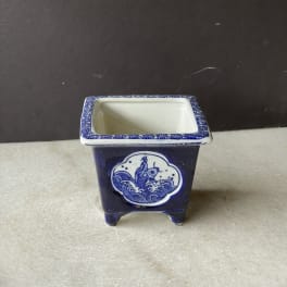 Blue-and-white ceramic square planter with a fish design