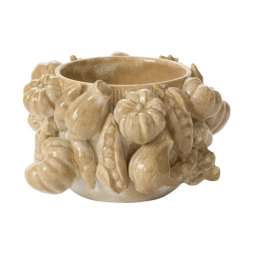 Beige ceramic bowl with raised pumpkin shapes around the outside