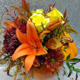 Bouquet of orange lilies, yellow roses, and dark mums