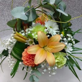 Mixed bouquet with orange lilies, white daisies, and greenery