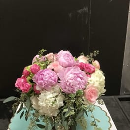 Pink and white floral arrangement in a vase
