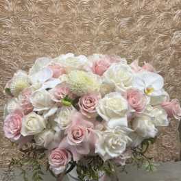 Bouquet of pale pink and white roses with orchids and mums
