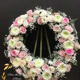 Pink and white rose wreath with white chrysanthemums on a stand