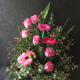 Pink roses and gerbera daisies in a lush mixed arrangement