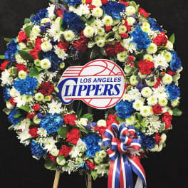 Large floral wreath with a Los Angeles Clippers sign and red, white, and blue ribbon
