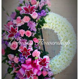 Pink and purple floral standing wreath with a large white heart shape