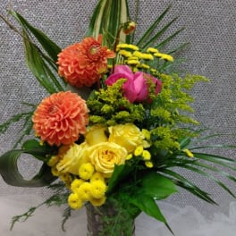 Colorful mixed flower arrangement in a glass vase