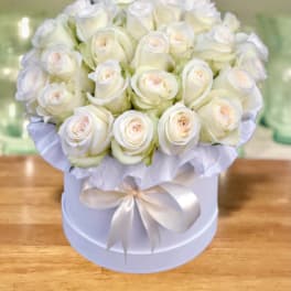 White rose bouquet in a round hat box with a satin ribbon