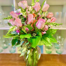 Pink roses and snapdragons in a clear glass vase
