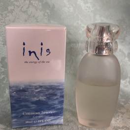 Pink cologne box beside a frosted glass perfume bottle