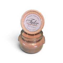 Peach scented candle in a glass jar with a round lid