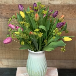 Bouquet of multicolored tulips in a white vase