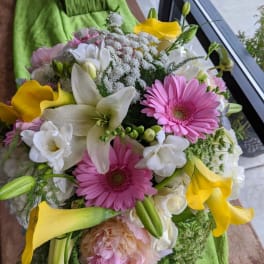 Bouquet of pink gerbera daisies, white lilies, and yellow calla lilies