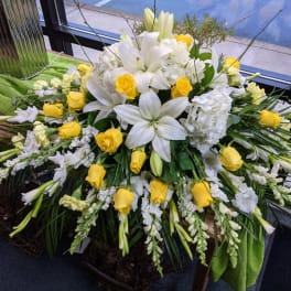 White lilies and yellow roses in a large floral spray
