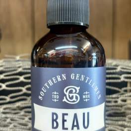 Bottle of Beau room spray with a clear cap and gray label