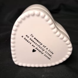 White heart-shaped ceramic keepsake with printed memorial text