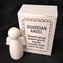 White guardian angel figurine beside a matching gift box