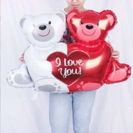 Two teddy bear balloons, one white and one red, with a heart that says I Love You!