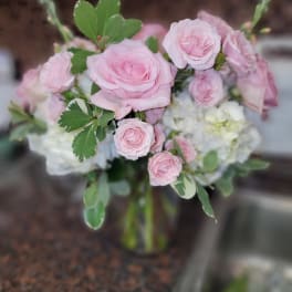 Pink roses and white hydrangeas in a glass vase