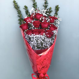Bouquet of red roses with white baby's breath in red wrapping